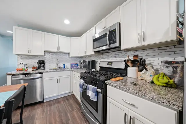 Updated white kitchen with stainless appliances